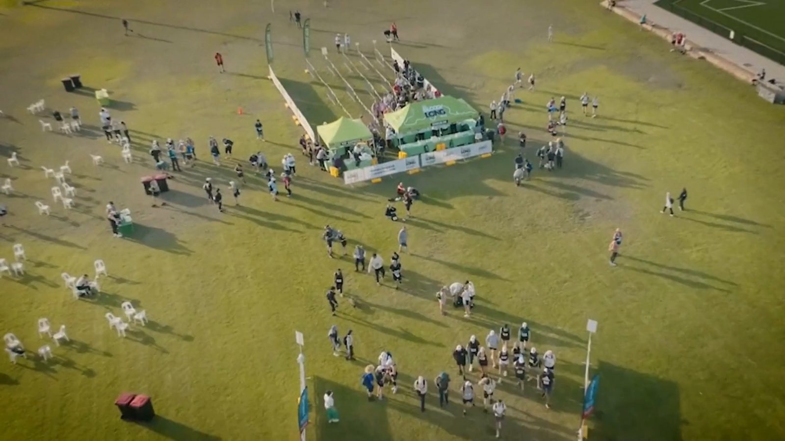 An aerial view of a community event on a playing field